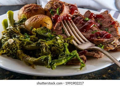 Steak and new potatoes with honey mesquite barbecue sauce and garlicky broccoli rabe - Shutterstock ID 1991902217