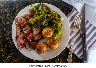 Steak and new potatoes with honey mesquite barbecue sauce and garlicky broccoli rabe - Shutterstock ID 1991902220
