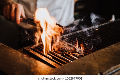 Steak on the grill with flames