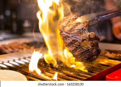 Steak on the grill with flames