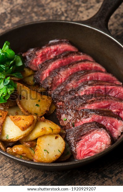 Steak and potatoes. Grade A grass fed angus beef\
steaks. Tenderloin, filet mignon, New York strip, bone in rib-eye\
grilled medium rare on outdoor wood-fired grill. Classic American\
steakhouse entree.