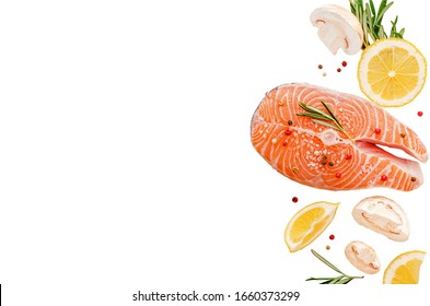 Steak Of Raw Fresh Salmon Fish With Mushrooms, Rosemary And Lemon Isolated On White. Top View, Keto Diet And Healthy Eating Concept. Copy Space