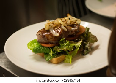 Steak Sandwich With Lettuce Tomato And Cooked Onion On White Toast.