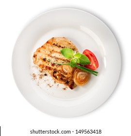 Steak With Tomatoes In A White Plate Isolated