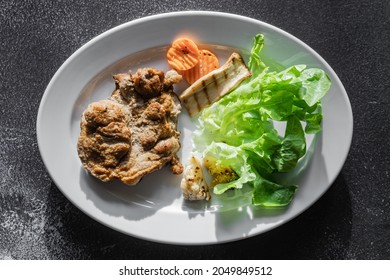 Steak With Vegetables And French Fries, Toast In Plate On Black Floor, Flat Lay Composition, Top View