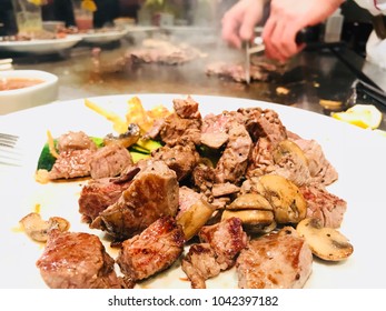 Steaks On The Plate In The Japanese Steakhouse With Chef’s Hands In The Background