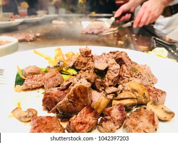 Steaks On The Plate In The Japanese Steakhouse With Chef’s Hands In The Background