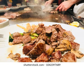 Steaks On The Plate In The Japanese Steakhouse With Chef’s Hands In The Background