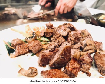 Steaks On The Plate In The Japanese Steakhouse With Chef’s Hands In The Background