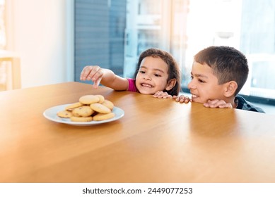 Steal, girl and boy in kitchen, cookies and siblings together, brother and sister in morning or hungry. House, kid and cute child for bonding or biscuits on table, plate and dessert in weekend - Powered by Shutterstock