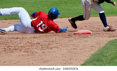 Stealing base sliding baseball runner