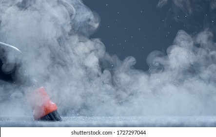 Steam close-up. Steam carpet cleaning on blue background. Home cleaning. Photo with copy space. - Shutterstock ID 1727297044