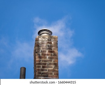 Steam Coming From A Brick Chimney With Gas Liner On A Cold Clear Day