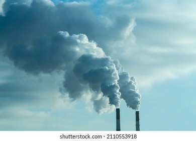 Steam coming out of pipes of thermoelectric power station in winter time. Termal power industry and environmental pollution concept and .