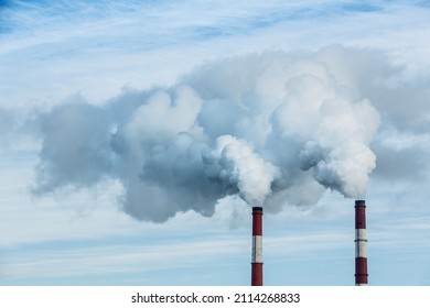 Steam coming out of pipes of thermoelectric power station in winter time. Termal power industry and environmental pollution concept and .