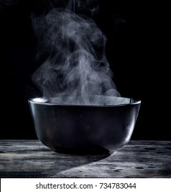 Steam Of Hot Soup In A Soup Bowl With Smoke On Black Background