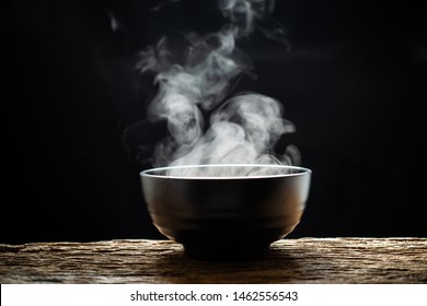 Steam Of Hot Soup With Smoke Wood Bowl On Dark Background.selective Focus.hot Food Concept