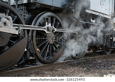 Steam locomotive rolling by close