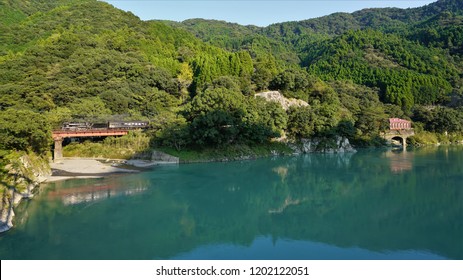 A Steam Locomotive Running Along The Kumagawa River And A Trace Of The Fukamizu Power Station, Power Station In The Historic Site, Kyushu, Japan, Kumamoto Prefecture,