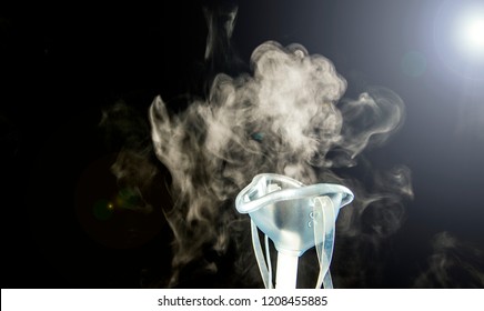 Steam mist from Nebulizer or nebuliser electrical machine drug delivery device used to administer medication in the form of a mist inhaled into the lungs concept. 