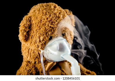 Steam Mist From Nebulizer Or Nebuliser Electrical Machine Drug Delivery Device Used To Administer Medication In The Form Of A Mist Inhaled Into The Lungs Concept. Toy Teddy Bear With Face Mask.