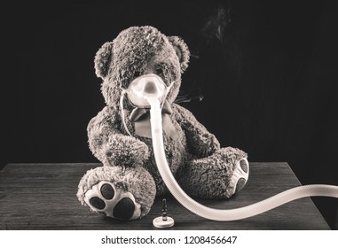 Steam Mist From Nebulizer Or Nebuliser Electrical Machine Drug Delivery Device Used To Administer Medication In The Form Of A Mist Inhaled Into The Lungs Concept. Toy Teddy Bear With Face Mask.  