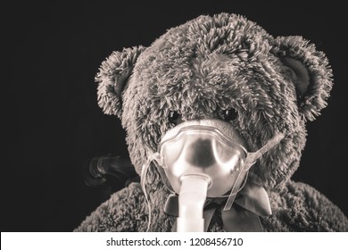 Steam Mist From Nebulizer Or Nebuliser Electrical Machine Drug Delivery Device Used To Administer Medication In The Form Of A Mist Inhaled Into The Lungs Concept. Toy Teddy Bear With Face Mask.