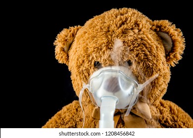 Steam Mist From Nebulizer Or Nebuliser Electrical Machine Drug Delivery Device Used To Administer Medication In The Form Of A Mist Inhaled Into The Lungs Concept. Toy Teddy Bear With Face Mask.