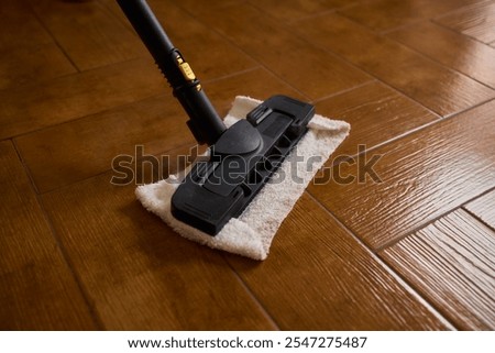 A steam mop serves as an efficient tool to clean wooden floors, showcasing the latest in modern cleaning technology