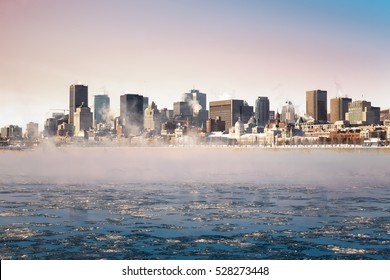 Steam rising from the frozen St Lawrence river at sunrise, with the Downtown district of Old montreal in the background.  - Powered by Shutterstock