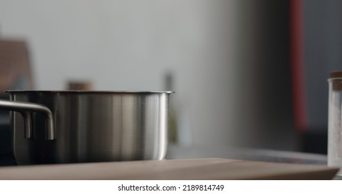 steam rising from saucepan with boiling water on stove, wide photo