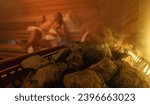 Steam rising from sauna stones with blurred people in the background, warm glowing light. relaxing in finnish sauna spa hotel concept image
