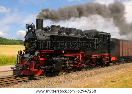 Steam train with black smoke; island Rugen, Northern Germany