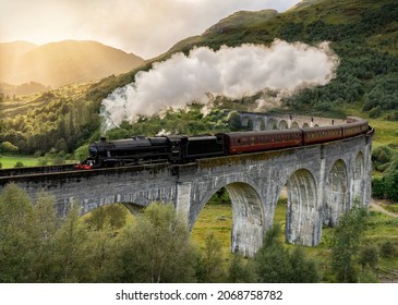 Steam train crossing the Glenfinnan viaduct in the Scottish Highlands, Scotland United Kingdom. Made famous in the Harry Potter movies - Shutterstock ID 2068758782
