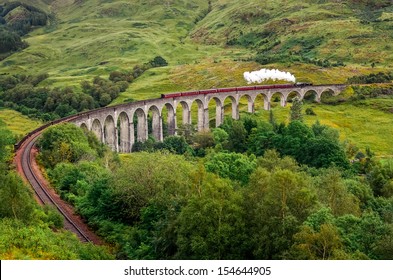 Steam Train On A Famous Glenfinnan Viaduct, Scotland, Great Britain