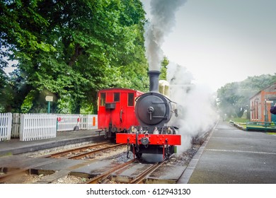 Steam Train On Railroad Station. Vintage Travel On Old Steam Train. Red Steam Train On Rail Station. Old Railway Road Isle Of Man. Vintage Travel On Old Locomotive. Vintage Travel Background. Old UK