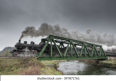 Steam Train Passes Over An Iron Bridge