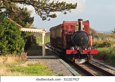 Steam Train Passing The Tiny, Rural Ballabeg Station, On The Isle Of Man Steam Railway