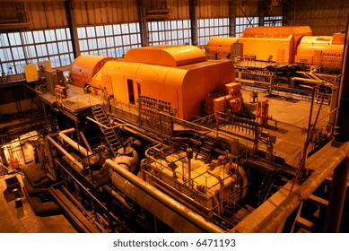 Steam Turbine And Different Size And Shaped Pipes At A Power Plant