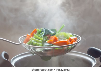 The Steam From The Vegetable Colander In The DarkSelective Focus.