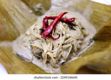 Steamed bamboo shoots is eating bamboo shoots. By mixing the ingredients, then wrapped in banana leaves and then steamed until cooked. have a mellow taste fragrant smell of banana leaves. - Shutterstock ID 2249146645