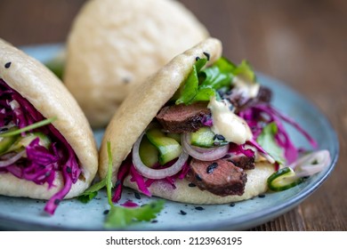 Steamed Bao Buns With Beef Steaak, Pickled Cucumber, Erd Cabbage And Mustard Mayo