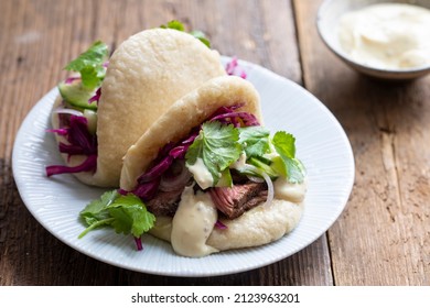 Steamed Bao Buns With Beef Steaak, Pickled Cucumber, Erd Cabbage And Mustard Mayo