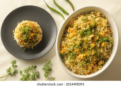 Steamed basmati rice tossed with a semi dry gravy of cottage cheese and bell peppers. Commonly known as Paneer rice in India. Shot on white background
