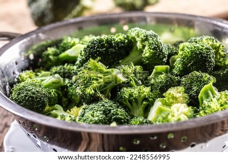 Steamed broccoli in a stainless steel steamer - Close up. Healthy vegetable concept.