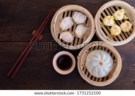 Steamed Bun and Shrimp Shumai, a steamed dish in a bamboo steamer box to enjoy the sweet tenderness of dried sakura shrimp., Name dim sum.