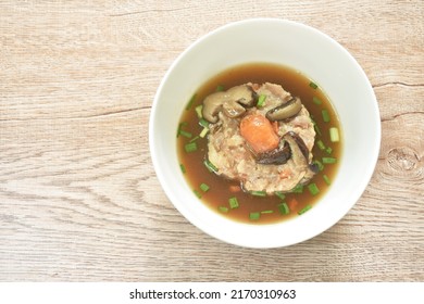 Steamed Chop Pork Topping Salty Egg Yolk With Mushroom In Gravy Sauce On Bowl 