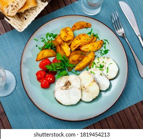 Steamed Cornish Salmon Steaks Served With Fried Potato Wedges, Pickled Tomatoes And Greens