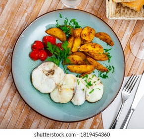 Steamed Cornish Salmon Steaks Served With Fried Potato Wedges, Pickled Tomatoes And Greens