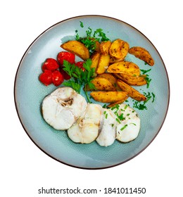 Steamed Cornish Salmon Steaks Served With Fried Potato Wedges, Pickled Tomatoes And Greens. Isolated Over White Background